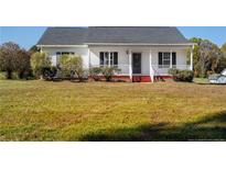 White house with front porch and landscaping at 732 N Pleasant Coats Rd, Benson, NC 27504