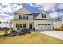 Two story home with a white exterior and large front yard at 808 Cypress Rd, Cameron, NC 28326