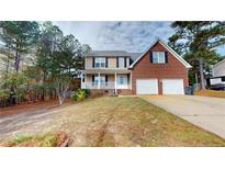 Brick two-story house with attached two-car garage and landscaped yard at 56 Briarwood Pl, Sanford, NC 27332