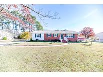 Brick ranch house with a landscaped lawn and walkway at 153 St Andrews Church Rd, Sanford, NC 27332