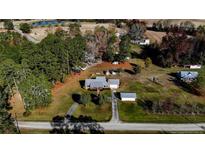 Aerial view of a ranch home on a large lot with detached garage and shed at 35 Rafter Creek Ln, Sanford, NC 27332