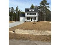 Two-story house with gray siding, white trim, and a covered porch at 772 Roberts Rd, Sanford, NC 27332