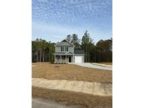 Two-story house with gray siding, attached garage, and landscaping at 788 Roberts Rd, Sanford, NC 27332