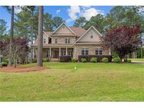 Two-story brick home with a large front porch and landscaped yard at 250 The Inner Cir, Spring Lake, NC 28390