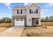 Two-story house with gray siding, white garage door, and a driveway at 912 Allstar Ave, Cameron, NC 28326