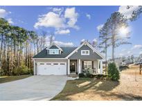 Gray two-story house with white trim, two-car garage, and a front porch at 40 Ringneck Ct, Lillington, NC 27546