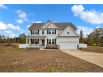 Two story house with gray siding, brick accents, and a large front porch at 48 Hemming Ct, Cameron, NC 28326