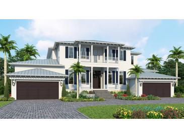 Stunning two-story home featuring a balcony, dark shutters, two-car garage, and lush landscaping at 118 N Warbler Ln, Sarasota, FL 34236