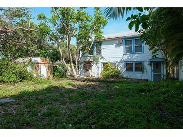 Large backyard with mature trees and a shed at 106 11Th S St # A, Bradenton Beach, FL 34217