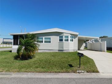 Charming single story home with a well-maintained lawn, carport and palm tree at 1532 46Th Avenue E Dr, Ellenton, FL 34222