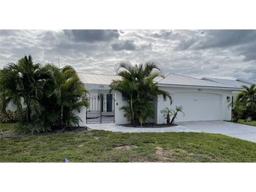 Single-story home with white exterior at 676 Key Royale Drive, Holmes Beach, FL 34217