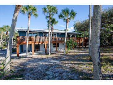 Elevated home with expansive deck overlooking treetops at 7720 Manasota Key Rd, Englewood, FL 34223