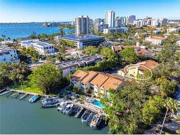 Aerial view of waterfront property with boat slips and nearby city skyline at 858 Hudson Ave # 858, Sarasota, FL 34236