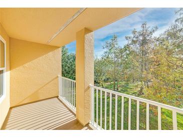 Private balcony overlooks lush green trees and a tranquil landscape at 8910 White Sage Loop, Lakewood Ranch, FL 34202