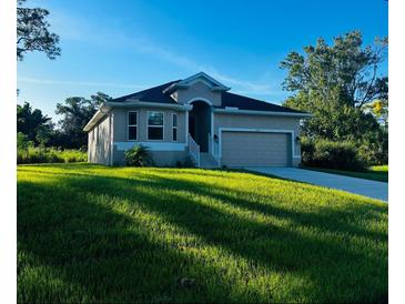 Single-story home with attached garage and lush lawn at 5655 Hale Rd, Venice, FL 34293