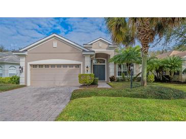 Single-story home with a two-car garage, landscaping, and a paver driveway at 12327 Thornhill Ct, Lakewood Ranch, FL 34202