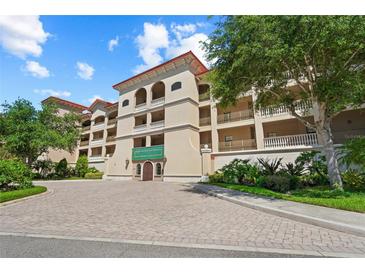 Inviting exterior of The Lake Vista Residences, featuring a Mediterranean style building with landscaping at 7710 Lake Vista Ct # 404, Lakewood Ranch, FL 34202