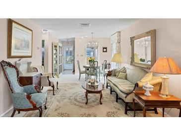 Elegant living room with antique furniture and a chandelier at 6033 Arlene Way # 3, Bradenton, FL 34207