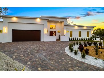 Stunning modern home featuring a beautiful circular driveway and manicured landscaping at 2512 Jefferson Cir, Sarasota, FL 34239