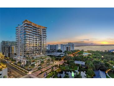 Luxury high-rise building with waterfront views at sunset at 668 Quay Commons # 506, Sarasota, FL 34236