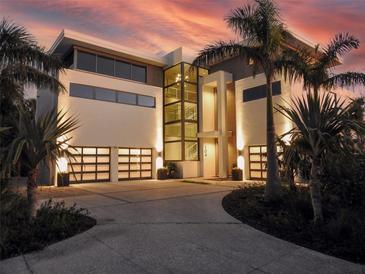 Luxury waterfront home with modern design and two-car garage at 104 Sunset Ln, Holmes Beach, FL 34217