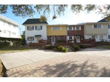 Three-unit townhome building with brick and siding at 705 W Venice Ave # 705-B, Venice, FL 34285