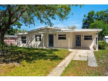 Ranch-style home with light-colored siding, landscaped yard at 2345 Floyd St, Sarasota, FL 34239