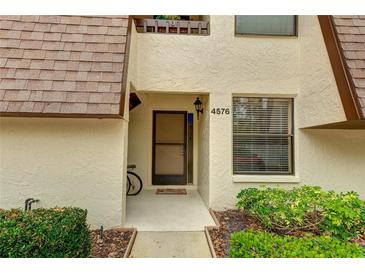 Condo building exterior with walkway and landscaping at 4576 Ringwood Mdw # 5, Sarasota, FL 34235