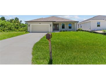 Newly built home with a two-car garage and driveway at 196 Arch Dr, Rotonda West, FL 33947