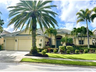 Beautiful two-story house with palm trees and lush landscaping at 14708 Sundial Pl, Lakewood Ranch, FL 34202