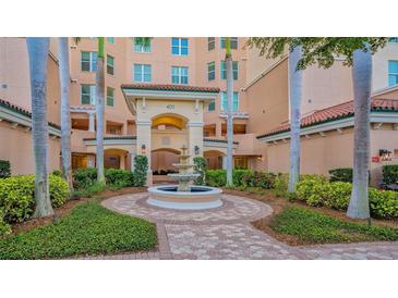 Attractive building exterior with a central fountain and landscaping at 401 N Point Rd # 301, Osprey, FL 34229