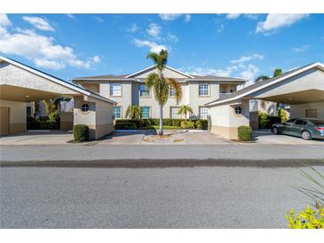 Two-story building with covered parking and lush landscaping at 2204 Auburn Lakes Cir # 2204, Venice, FL 34292