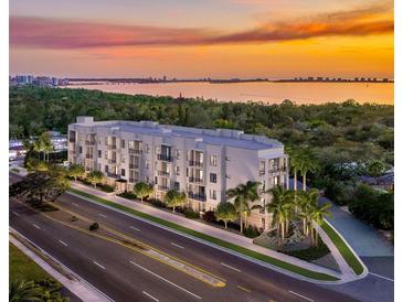 Modern building with water views at sunset at 4950 Remington Dr # 401, Sarasota, FL 34234