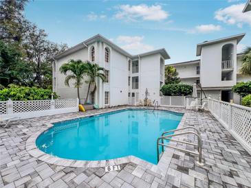 Beautiful in-ground swimming pool with palm trees and lounge chairs at this condo complex at 6304 Pointe West Blvd # A102, Bradenton, FL 34209