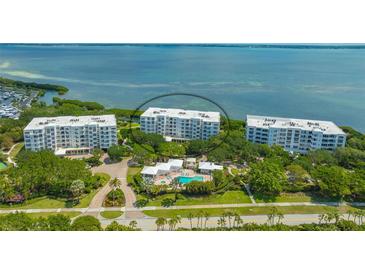 Luxury condo building with waterfront and pool views at 2450 Harbourside Dr # 212, Longboat Key, FL 34228