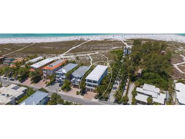 Aerial view of beachfront home near the ocean at 809 N Shore Dr, Anna Maria, FL 34216