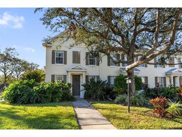 Two-story townhome with shutters, walkway, and landscaping at 5654 Simonton St, Bradenton, FL 34203