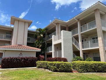 Two-story condo building with manicured landscaping at 6503 Stone River Rd # 109, Bradenton, FL 34203