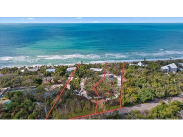 Oceanfront property with expansive beach views and lush landscaping at 7730 Manasota Key Rd, Englewood, FL 34223
