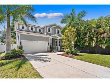 Two-story house with gray siding and white garage door at 1800 Robinhood St, Sarasota, FL 34231