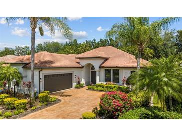 Single-story home with tile roof and landscaped yard at 13906 Siena Loop, Lakewood Ranch, FL 34202