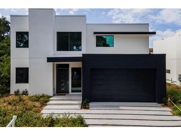 Modern two-story home with black garage door and light-colored exterior at 1734 Wisconsin Ln, Sarasota, FL 34239