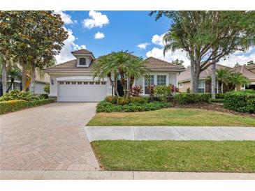 Charming single-story home with lush landscaping and a brick-paved driveway at 7249 Orchid Island Pl, Bradenton, FL 34202