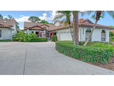 Two-story home with tile roof, lush landscaping and a large driveway at 4440 Calle Serena, Sarasota, FL 34238