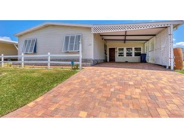 Mobile home with carport and brick paved driveway at 1508 45Th E Ave, Ellenton, FL 34222