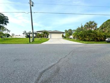 Single-Gathering home with a two car garage and tropical landscaping at 2760 Chipley Ave, North Port, FL 34286
