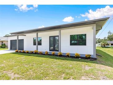 Modern house exterior with a two car garage at 4549 Targee Ave, North Port, FL 34287