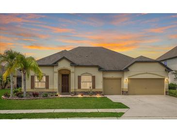 Inviting single-story home featuring a well-manicured lawn and an attached two-car garage at 6309 75Th E Ave, Palmetto, FL 34221