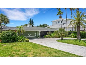 House exterior showcasing a lush green lawn and driveway at 701 Armada S Rd, Venice, FL 34285