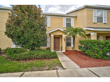 Two-story townhome with attractive landscaping and a walkway at 14939 Amberjack Ter # 102, Lakewood Ranch, FL 34202